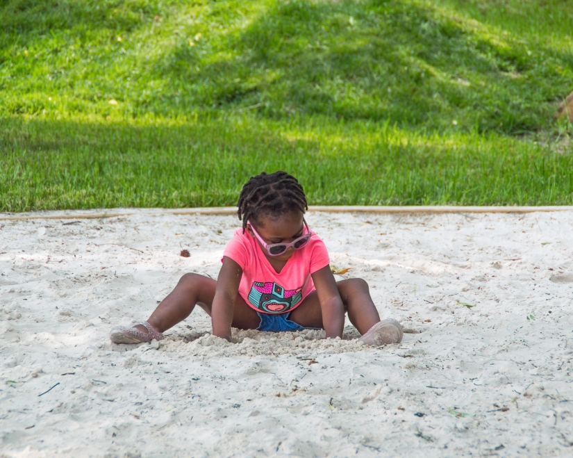 Maxine is playing in a large sandbox